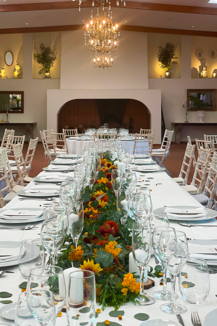 a long table with a chandelier hanging above it