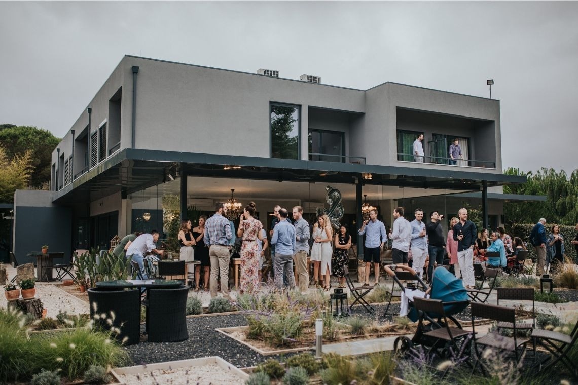a group of people are gathered in front of a large building