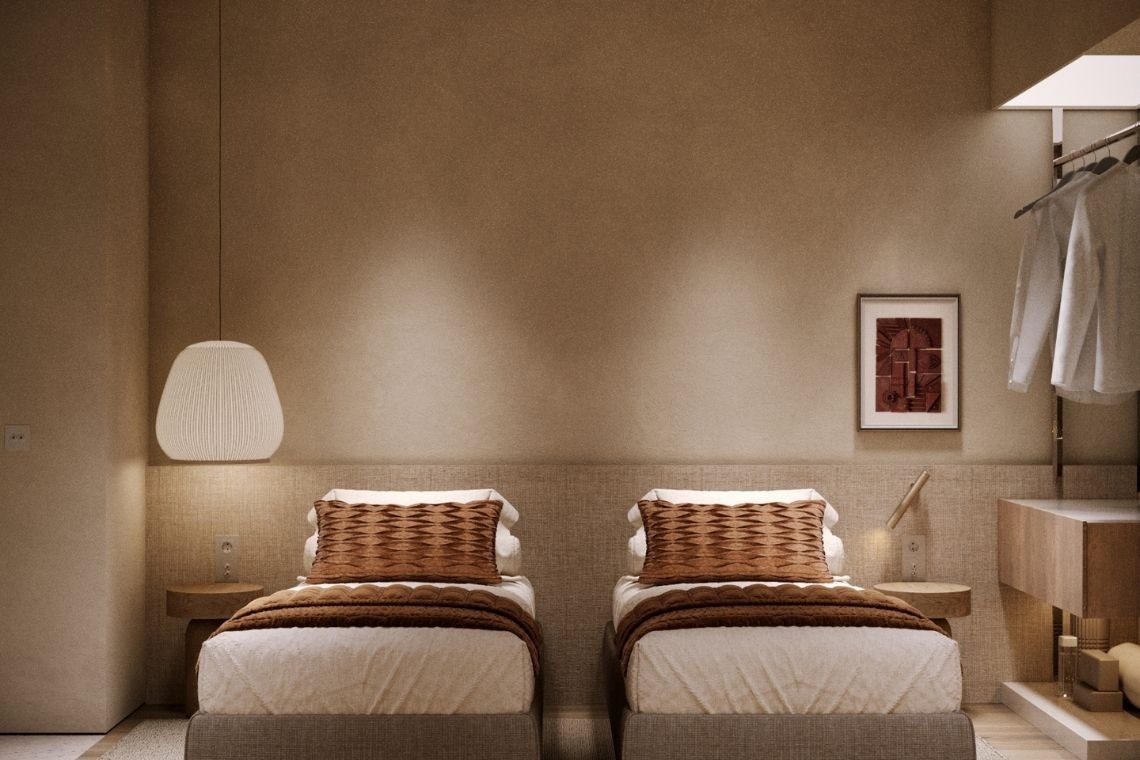 a bedroom with two beds and a picture on the wall