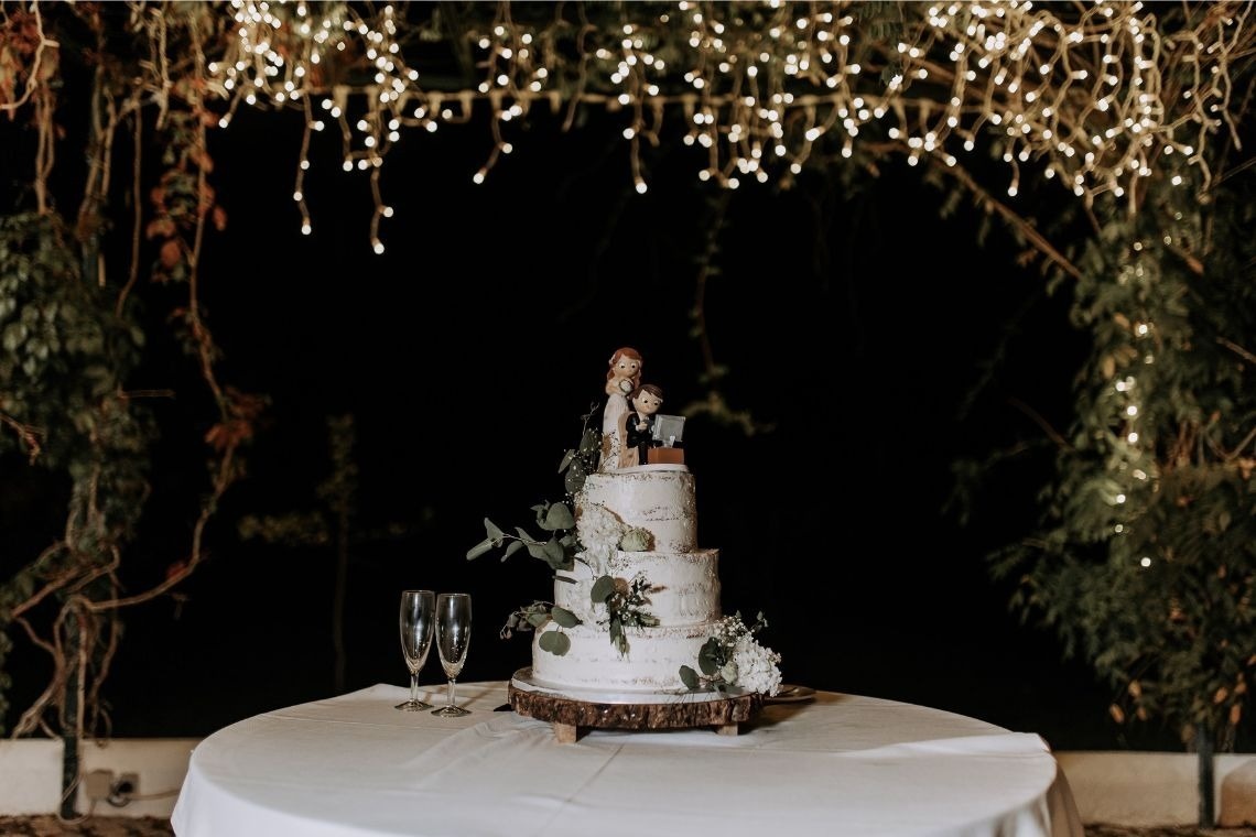 a wedding cake with a bride and groom figurine on top