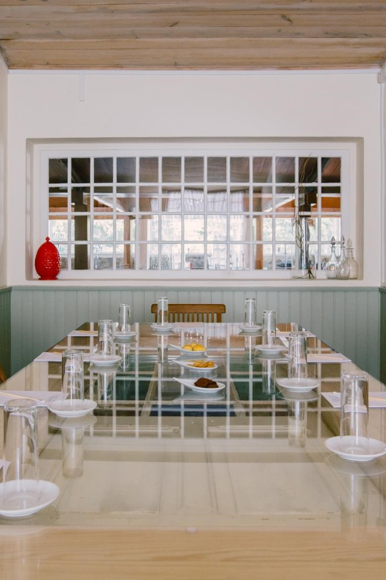 a long table with plates and glasses on it