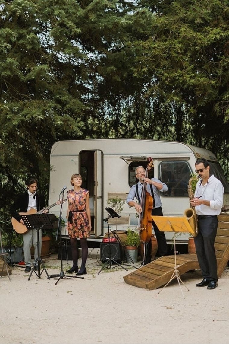 a group of musicians are playing in front of a trailer