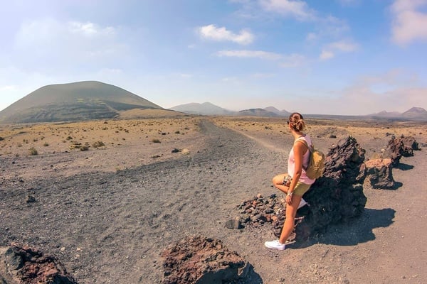 a bride and groom standing on a bridge over a swimming pool