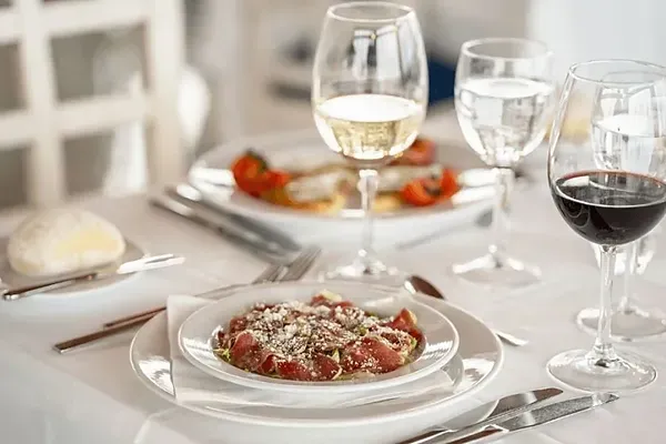 R2 Hotels: Corporate dinner table set at restaurant with ocean views.