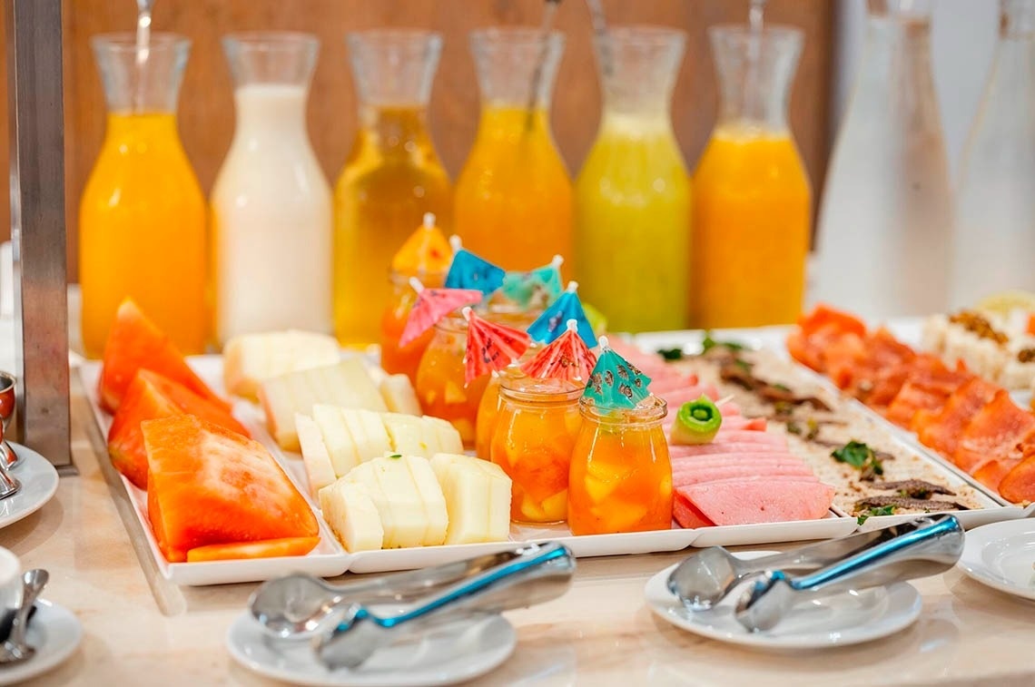 a woman wearing sunglasses is sticking her tongue out in a swimming pool