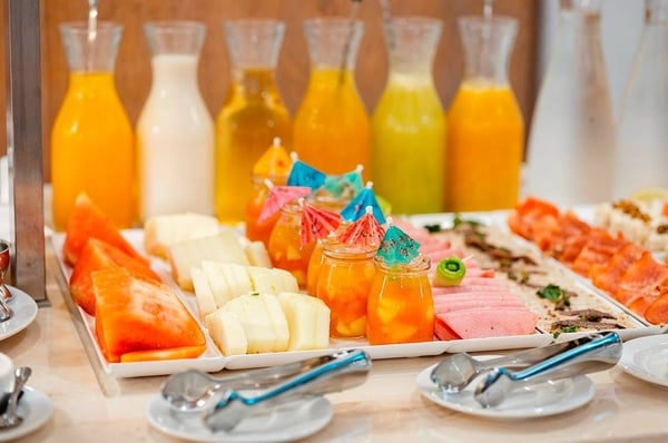 a woman wearing sunglasses is sticking her tongue out in a swimming pool
