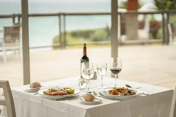 R2 Hotels: Corporate dinner table set at restaurant with ocean views.