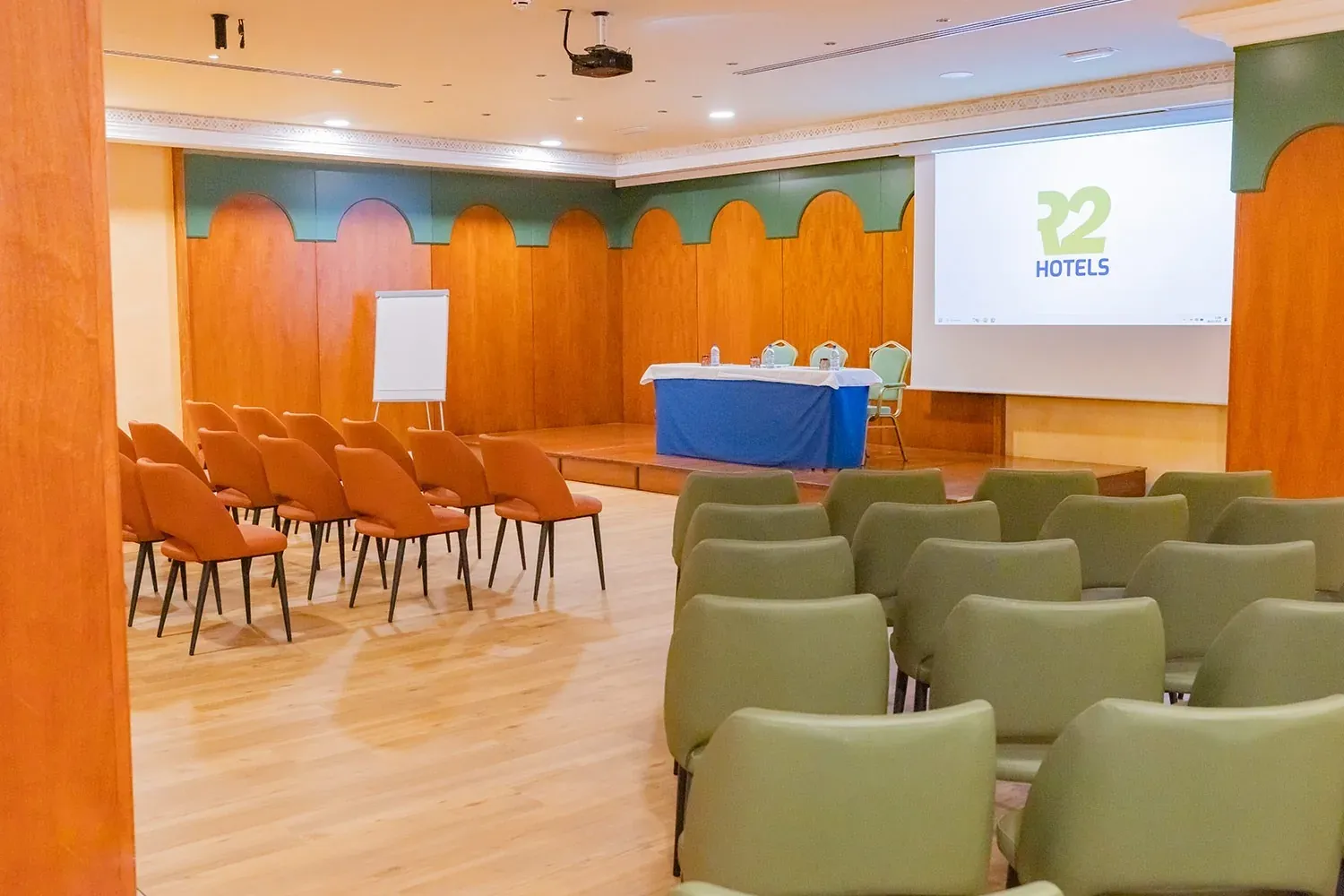 R2 Hotels Konferenzraum: perfekt für Firmenevents mit bequemen Stühlen.