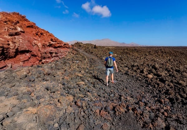 a woman taking a picture of a building with a camera