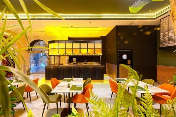 a woman wearing sunglasses is sticking her tongue out in a swimming pool