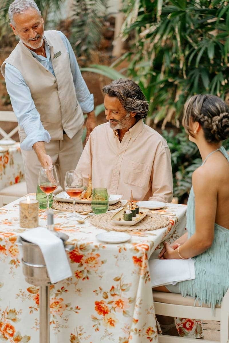 a woman pouring water from a bottle that says bacco