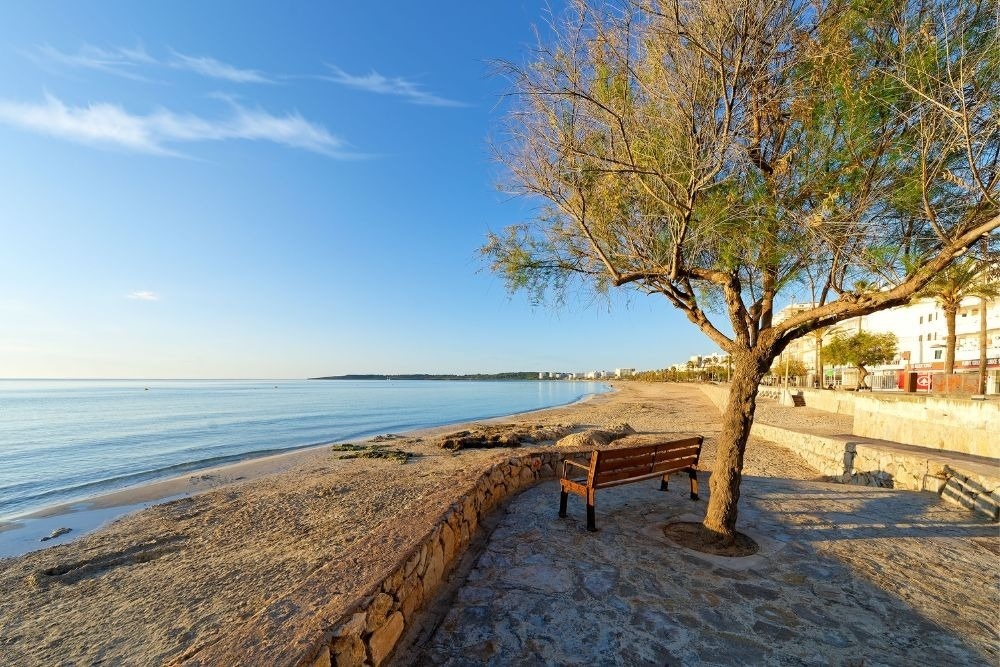 a white chair sits next to a tall white table