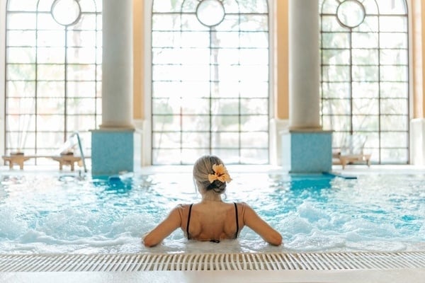 a woman taking a picture of a building with a camera