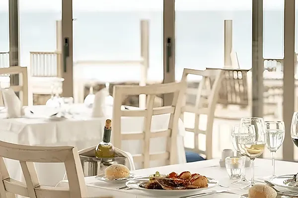 R2 Hotels: Corporate dinner table set at restaurant with ocean views.
