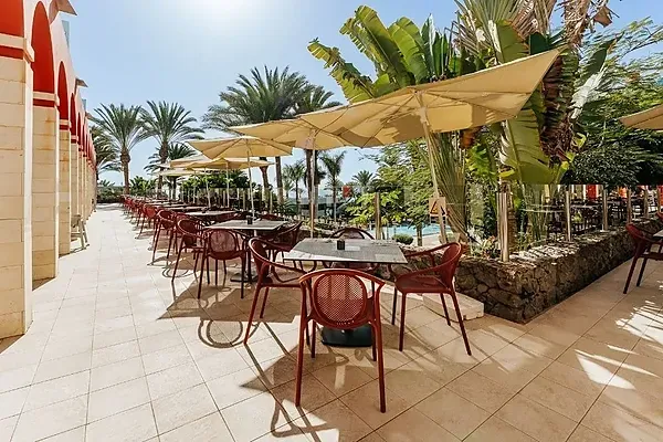 R2 Hotels: Spacious buffet with tables and chairs set for service.