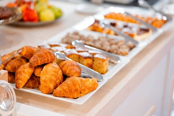 a woman wearing sunglasses is sticking her tongue out in a swimming pool