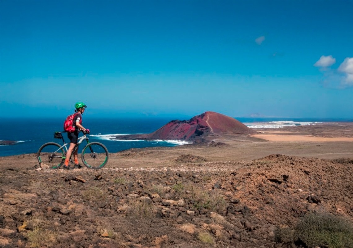 a woman taking a picture of a building with a camera