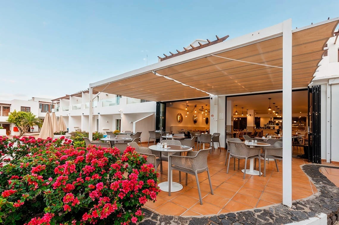 a woman wearing sunglasses is sticking her tongue out in a swimming pool