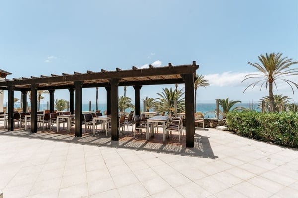 a woman wearing sunglasses is sticking her tongue out in a swimming pool