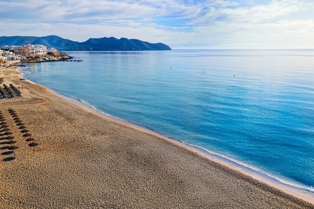 a woman taking a picture of a building with a camera