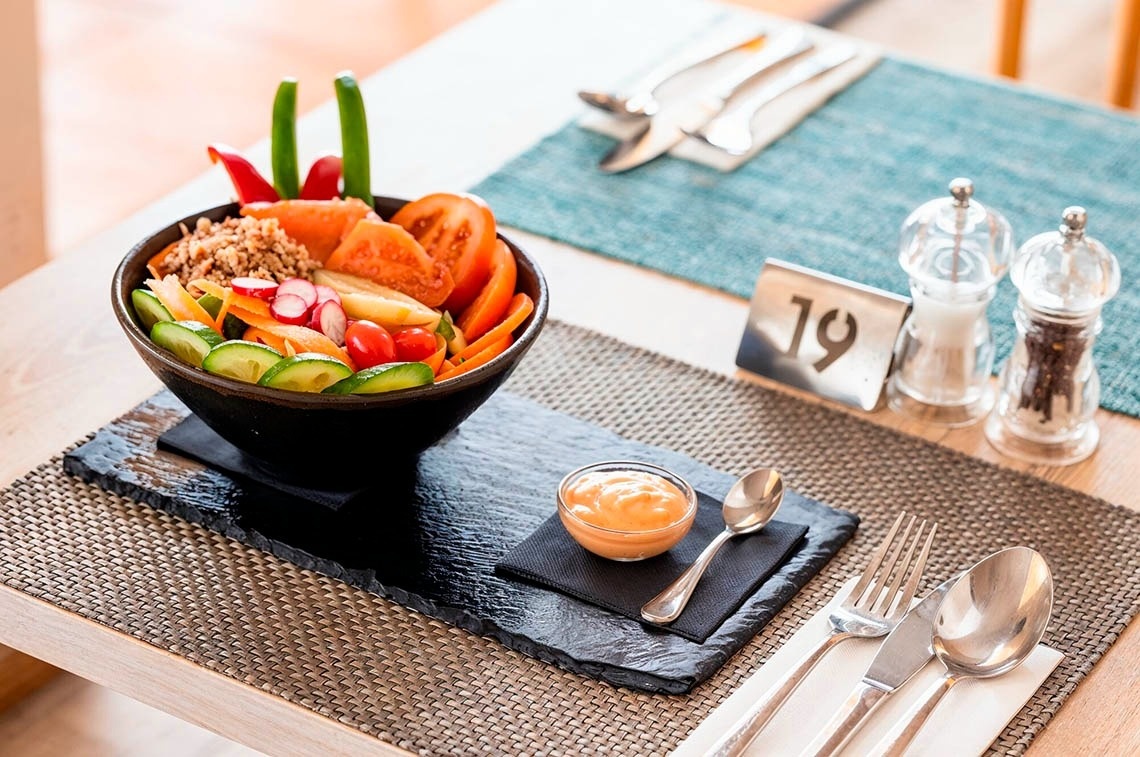 a woman wearing sunglasses is sticking her tongue out in a swimming pool