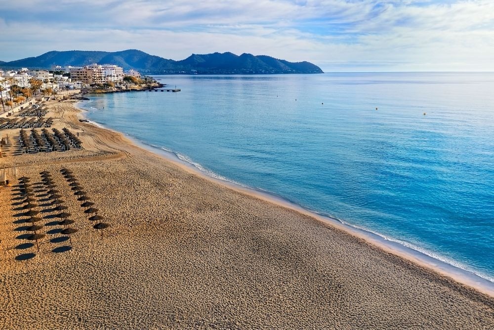 a white chair sits next to a tall white table