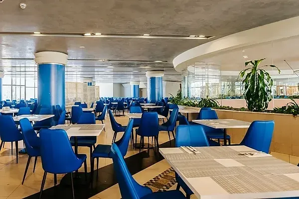 R2 Hotels: Spacious buffet with tables and chairs set for service.