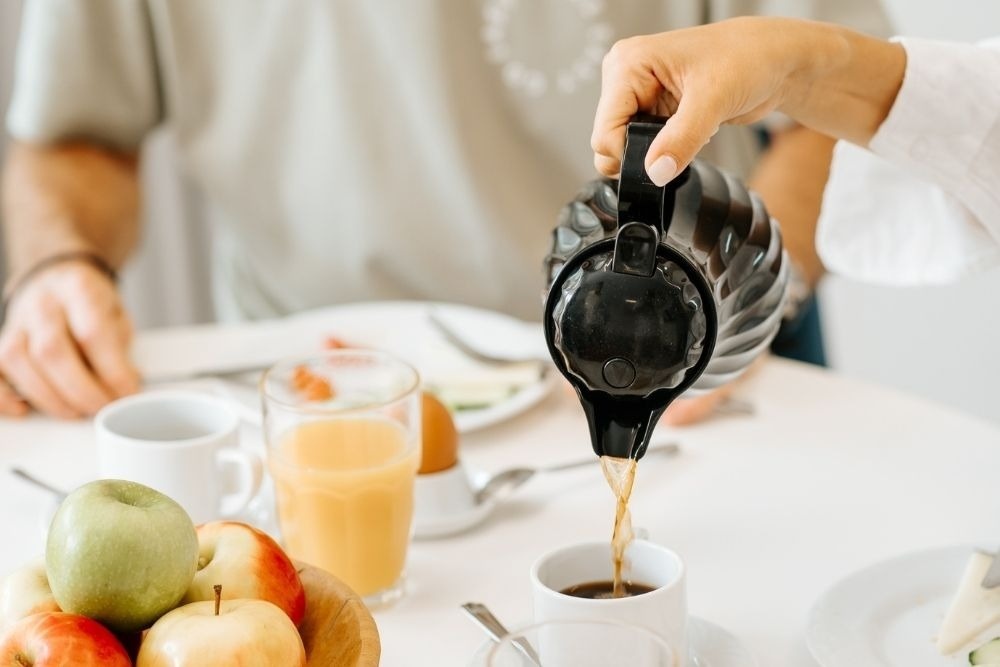 a woman wearing sunglasses is sticking her tongue out in a swimming pool