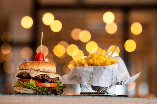 a woman wearing sunglasses is sticking her tongue out in a swimming pool