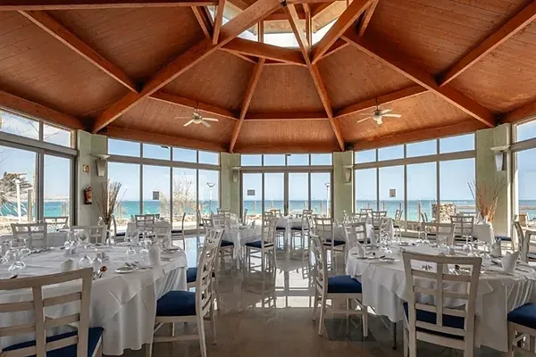 R2 Hotels: Corporate dinner table set at restaurant with ocean views.