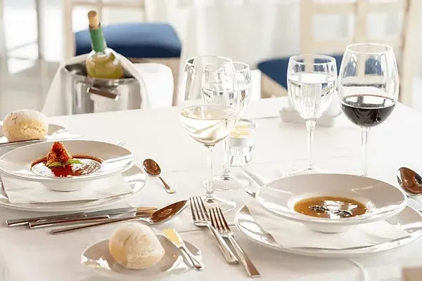 R2 Hotels: Corporate dinner table set at restaurant with ocean views.