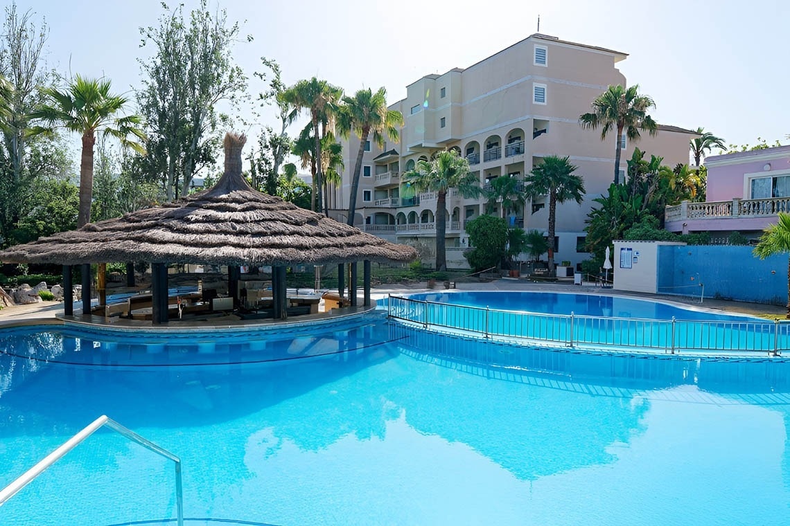 a white chair sits next to a tall white table