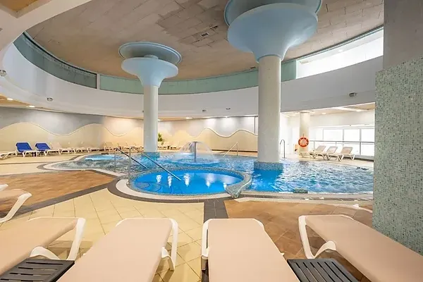 R2 Hoteles: Corporate indoor pool with waterfalls and jacuzzi.