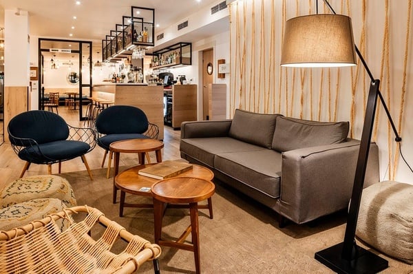 a woman wearing sunglasses is sticking her tongue out in a swimming pool