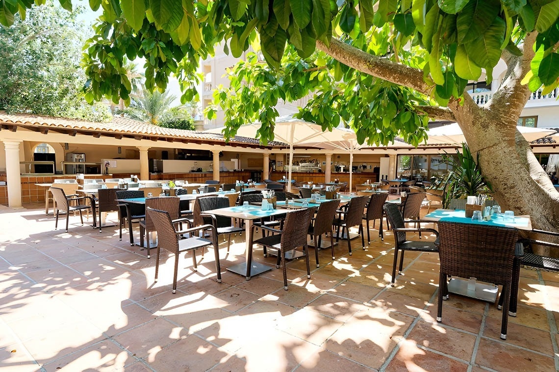 a woman wearing sunglasses is sticking her tongue out in a swimming pool