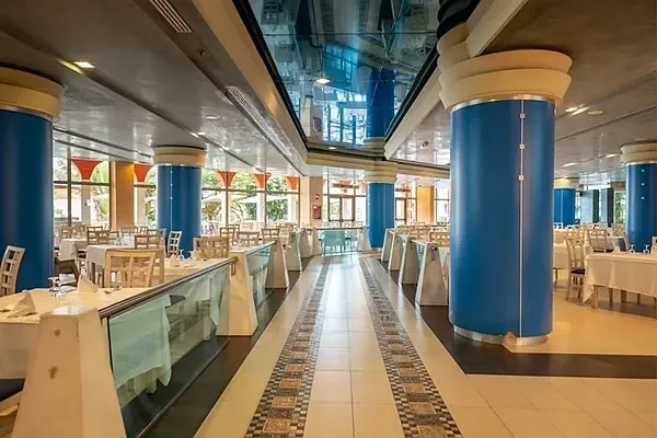 R2 Hotels: Spacious buffet with tables and chairs set for service.