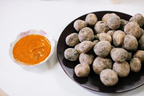 an aerial view of a beach with mountains in the background
