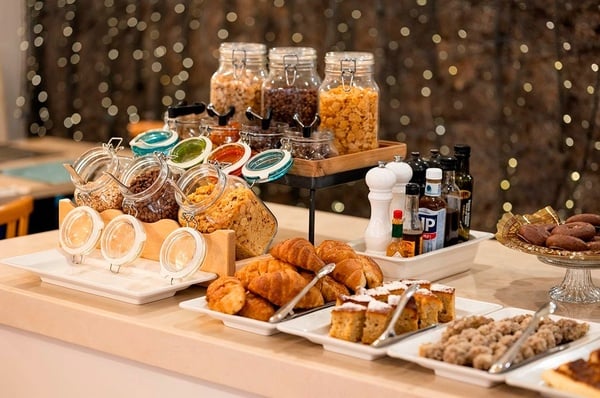 a woman wearing sunglasses is sticking her tongue out in a swimming pool