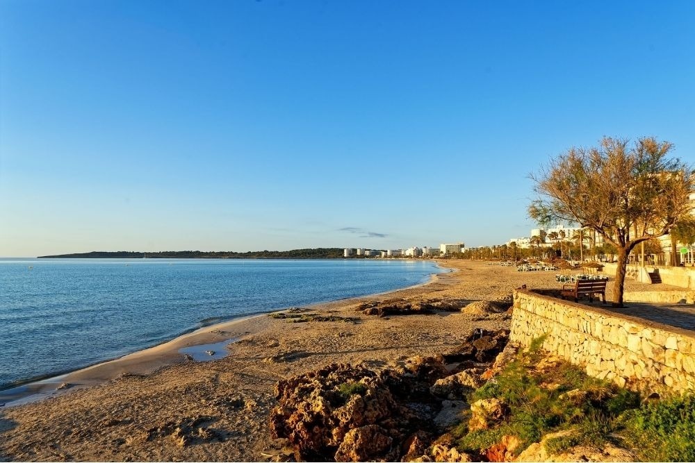 a woman taking a picture of a building with a camera