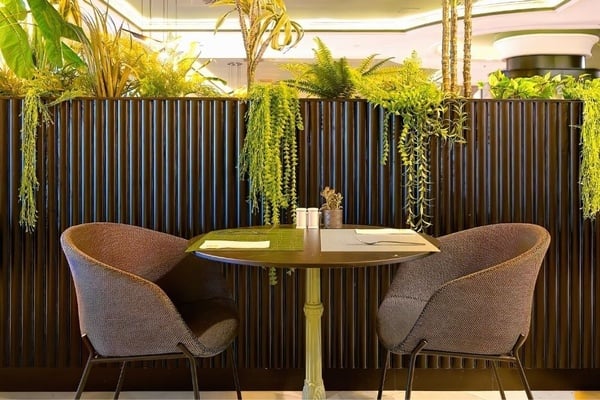a woman wearing sunglasses is sticking her tongue out in a swimming pool