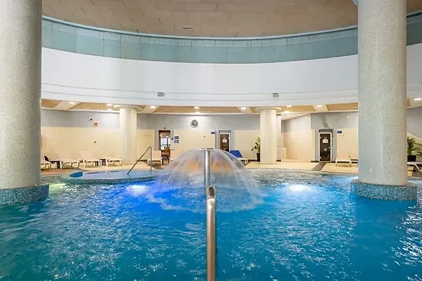 R2 Hoteles: Corporate indoor pool with waterfalls and jacuzzi.