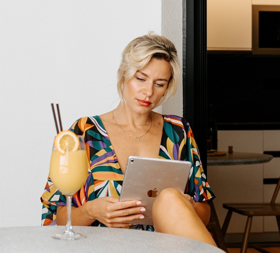 a woman in an orange shirt paints a child 's face