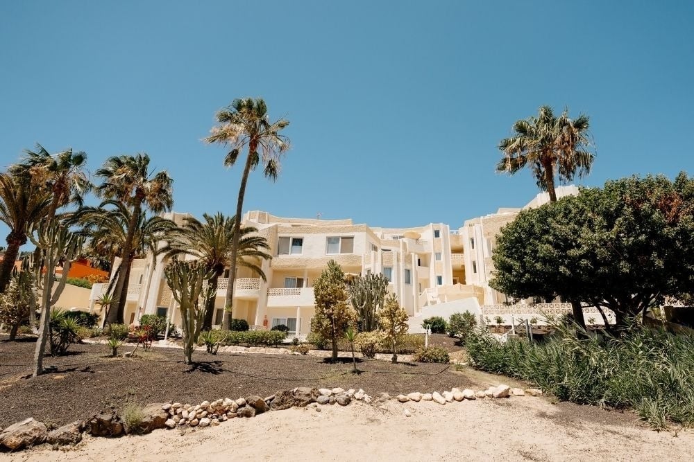 R2 Maryvent Beach Apartment building with palm trees and blue sky