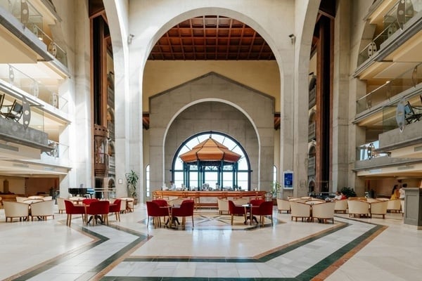 a woman wearing sunglasses is sticking her tongue out in a swimming pool