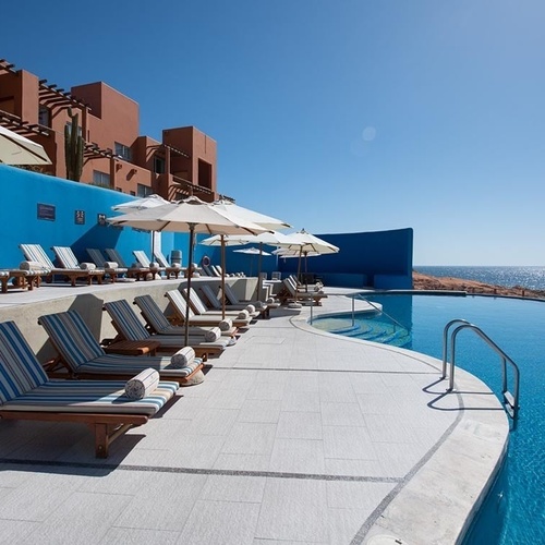Travel Raintree Corpo resort infinity pool with ocean view and lounge chairs.