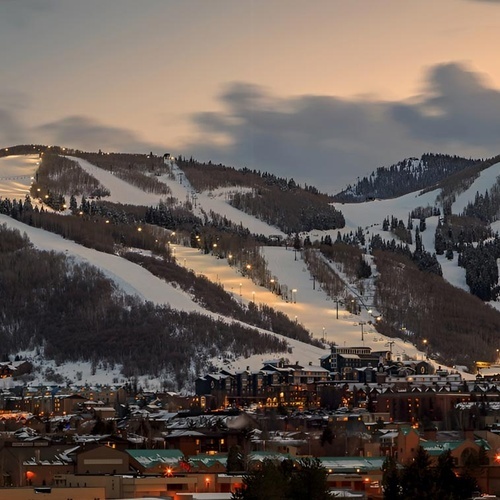 Travel Raintree Corpo: Snowy mountains and city lights.