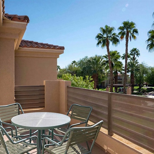Balcony with table & chairs, pool & palm view, perfect for Travel Raintree Corpo.