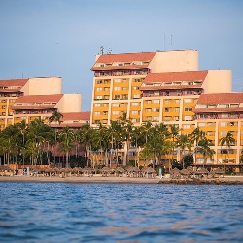 Travel Raintree Corpo resort with palm trees and ocean views.