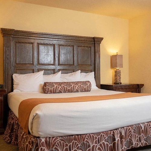 Comfortable king-size bed in a Travel Raintree Corpo hotel room.