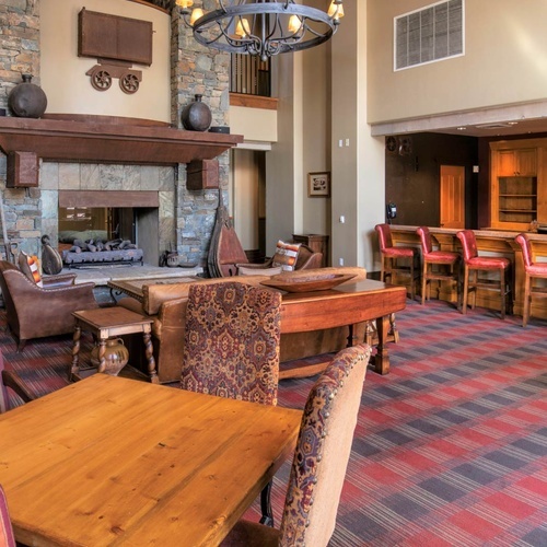Luxury hotel lobby with stone fireplace and bar, perfect for Travel Raintree Corpo.